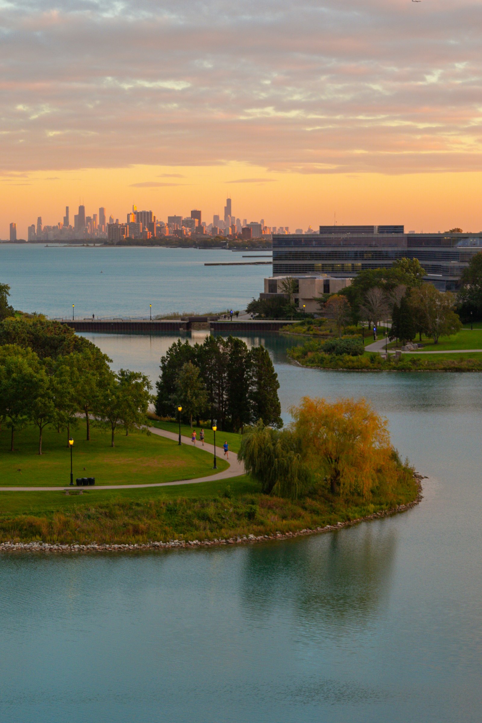 Lakeside campus with a distant city skyline
